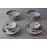 A pair of Spode porcelain tea cups and saucers with moulded floral decoration and gilt borders