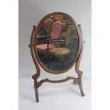 An oval mahogany adjustable dressing table mirror on skeleton framed stand 40cm wide