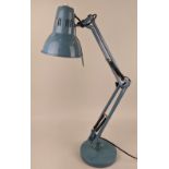 An Anglepoise style metal desk lamp in blue, with adjustable shade and arm on circular base