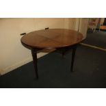 A George III mahogany drop-leaf gate-leg dining table, with oval top on turned tapered legs to pad