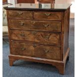 An 18th century inlaid walnut chest of two short over three long drawers with crossbanded top and