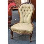 A Victorian button upholstered chair with carved balloon back on cabriole legs
