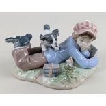 A Lladro figure of a child reading with bird and spaniel, 9cm high
