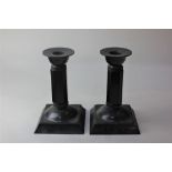 Just Andersen, a pair of bronze dwarf candlesticks facetted stems on square bases, stamped Just