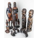 A collection of carved hardwood African figures, various poses, tallest 62cm high
