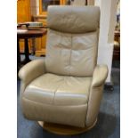 A Sitbest of Norway beige leather reclining armchair on circular swivel base