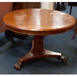 A Victorian mahogany circular breakfast table with tilt top on tapering column support and trefoil