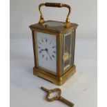A brass and bevelled glass cased repeater carriage clock, the movement stamped Paris, striking on