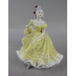 A Royal Doulton porcelain figure of a lady 'Ninette', wearing a yellow gown, 21.5cm high