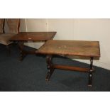 A pair of oak refectory style side tables with rectangular tops on pierced end supports with central