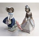 A Lladro porcelain figure of a girl with a pink umbrella, 19.5cm high, and another of a girl holding