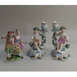 A pair of Dresden porcelain cherub candlesticks seated on scroll bases (a/f) 19cm and a male and