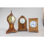 An Edwardian style lancet shaped mantle clock, the circular white enamel dial with Roman numerals,