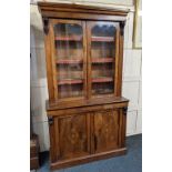 A Victorian inlaid walnut bookcase the top with twin glazed doors enclosing three shelves with