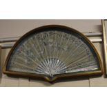 A framed mother of pearl, painted silk and lace fan, decorated with birds amongst blossom and signed