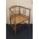 An early 20th century oak rush seated elbow chair on tapered legs