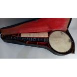 A cased banjo labelled Challenge Banjo, London, (a/f) 89cm
