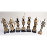 A set of six ceramic mannequins with detachable gilt metal armour depicting military figures; to