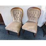 A pair of Victorian button back upholstered nursing chairs, on turned front legs and castors