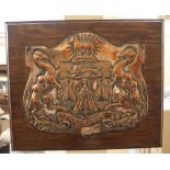 A plated copper and oak armorial wall plaque with crest and motto of the Worshipful Company of