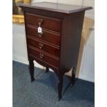 An Arts and Crafts music cabinet four fold down drawer fronts and brass heart shape handles on