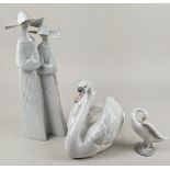Three Lladro porcelain models; a white swan, 19cm high, a figure group of two nuns, 35.5cm high, and