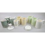 Wedgwood designed by Keith Murray; a candlestick, an ashtray, and nine mugs, in white, yellow and
