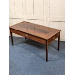 An inlaid mahogany rectangular coffee table with crossbanded top and oval flame veneered centre,