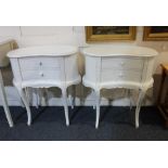 A pair of white kidney shaped bedside tables with two drawers on cabriole legs, 65cm
