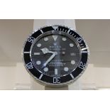 A modern aluminium wall clock in the form of a Rolex Oyster Perpetual Date Submariner