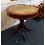 A reproduction mahogany drum table with leather inset top and two drawers, on turned baluster stem