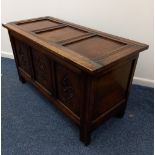 A small oak coffer with carved three panel front, 92cm