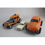 An Aoshin tinplate and battery operated model Volkswagen Beetle, a Taiyo FBI Godfather battery