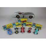 A West German tin plate Mercedes Benz model racing car in silver, possibly JNF, together with five