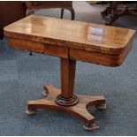 A Victorian rosewood card table with baise lined fold over rectangular top on facetted stem and