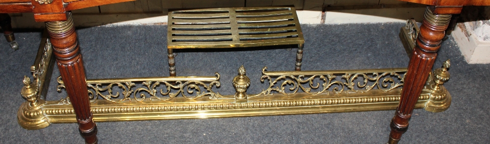 A brass fire fender with pierced scroll rail and central vase finial, 137cm and a rectangular