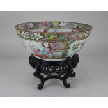 A Chinese Cantonese famille rose porcelain bowl, decorated with panels of figural scenes amongst