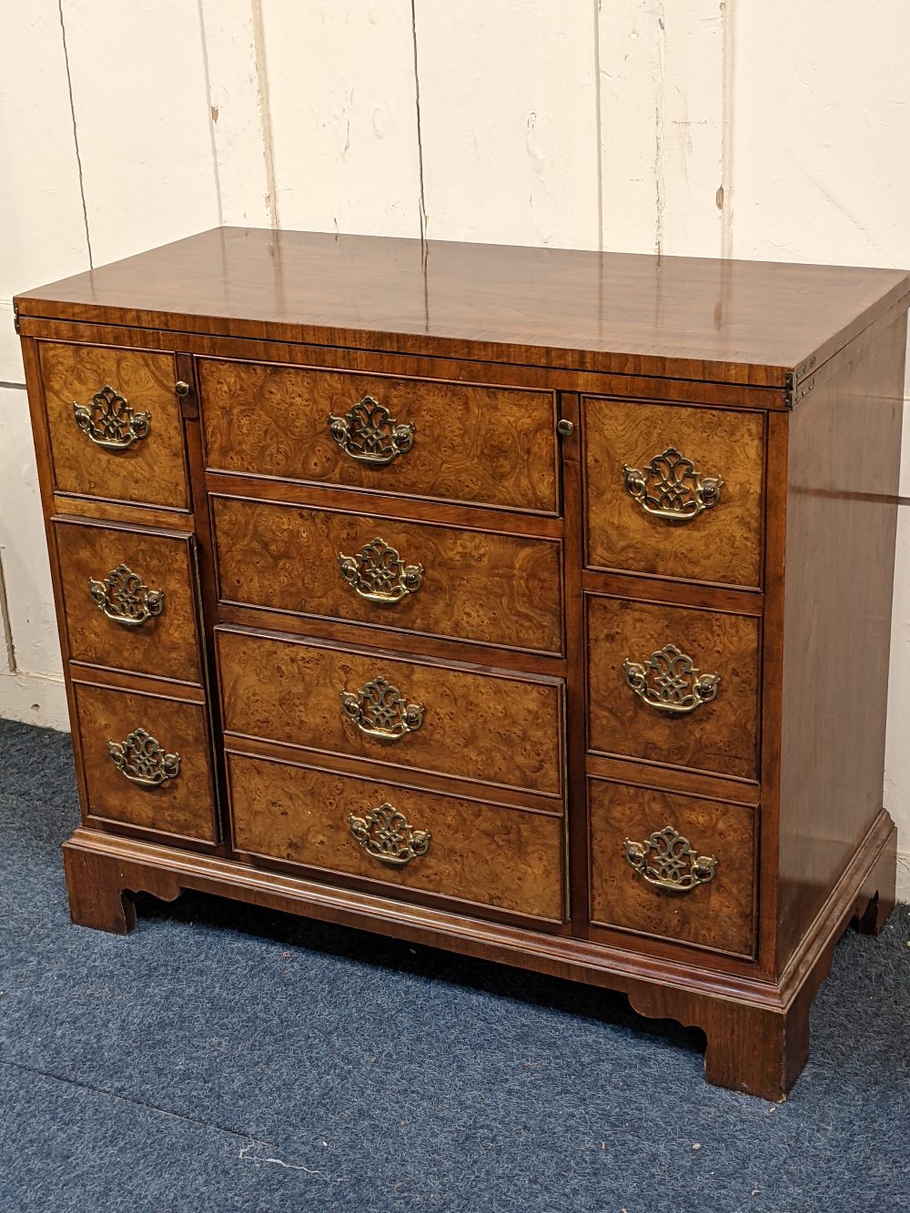 An American Baker Furniture reproduction bachelor chest with rectangular fold over top above an