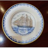 A Poole pottery 'Waterwitch' plate decorated with a sailing ship, made and painted in the year 1955,