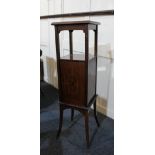 An Edwardian inlaid mahogany pot stand with square top and central cupboard with inlaid geometric