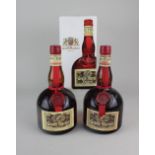 Two bottles of Grand Marnier liqueur, one boxed
