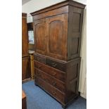 A George III oak press cupboard with two panelled door top enclosing two shelves on base with two