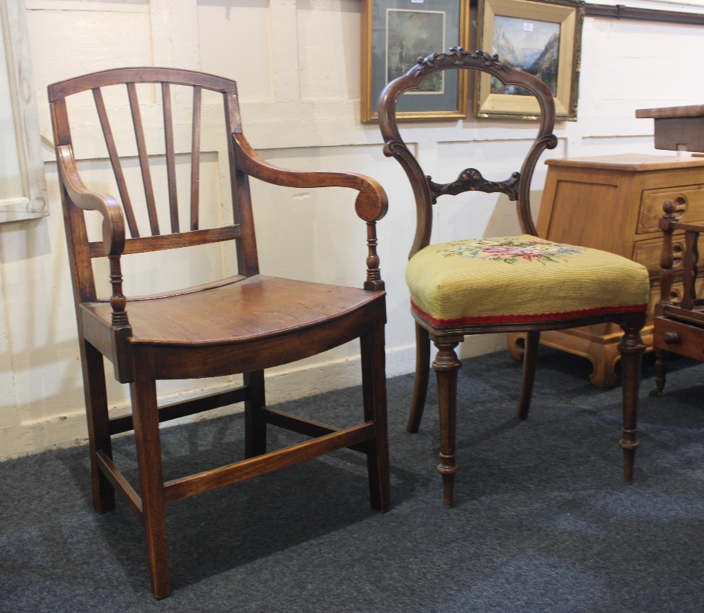 A Victorian carved balloon back dining chair with tapestry seat and an oak elbow chair with solid