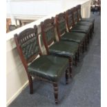 A set of six Victorian carved dining chairs with green leather button upholstered backs and stuff