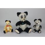 A Berg panda teddy bear, 34cm high, together with a panda teddy bear with blue eyes 20cm high, and a