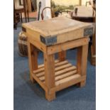 A butchers block with metal mounts on pine stand with slatted undertier, 65cm