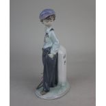 A Lladro porcelain figure of a boy 'The Wanderer', 21cm high, with box