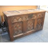 An 18th century carved oak coffer with carved three panel front, 98cm