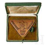 A Golf Association AwardMaker “LK”, triangular bronze metal award, obverse with embossed folded wing