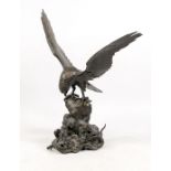 Large, Chinese sculpture of an eagle with spread wings over rock base with plastic